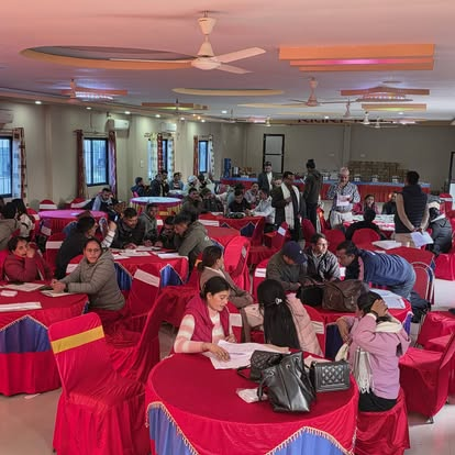 Students writing at a campus programme